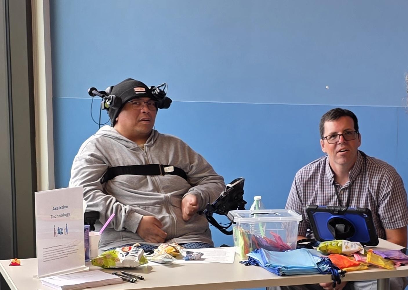 Two board members of Upstream Access using assistive tech
